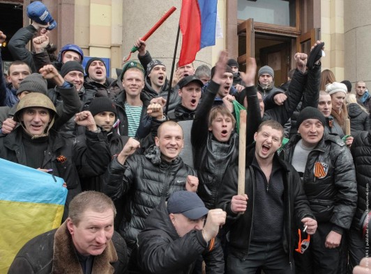 Pro-Russian protesters celebrate after clashes with supporters of Ukraine's new government in central Kharkiv